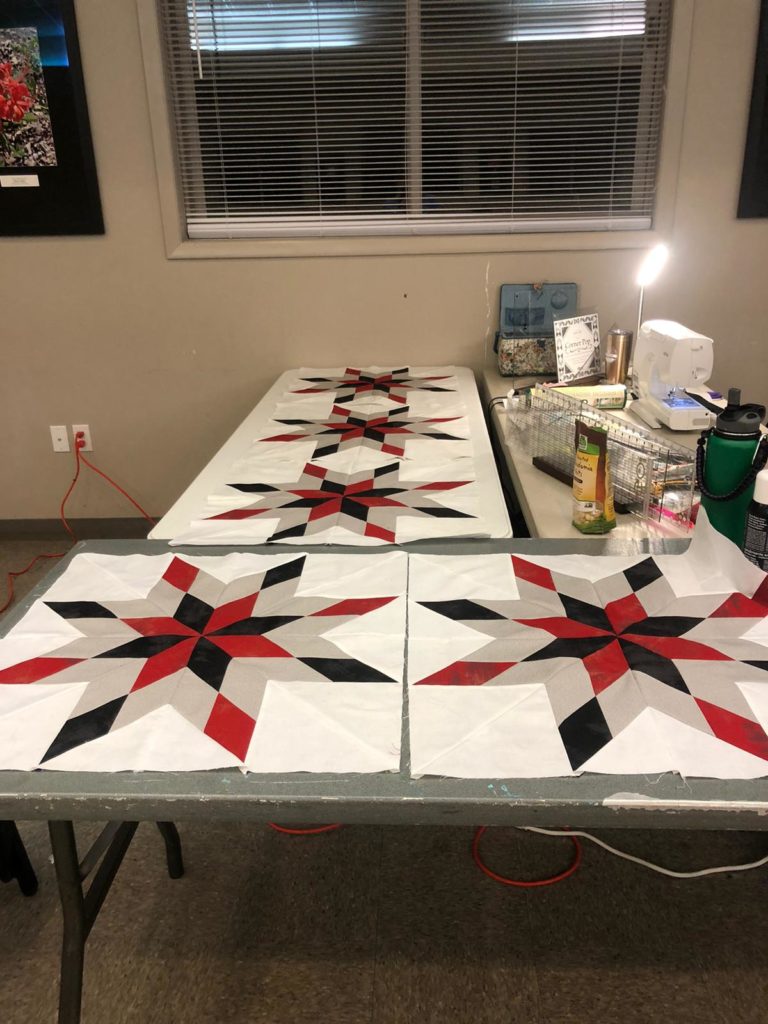 A quilter's workshop contains rulers, a sewing machine and snacks